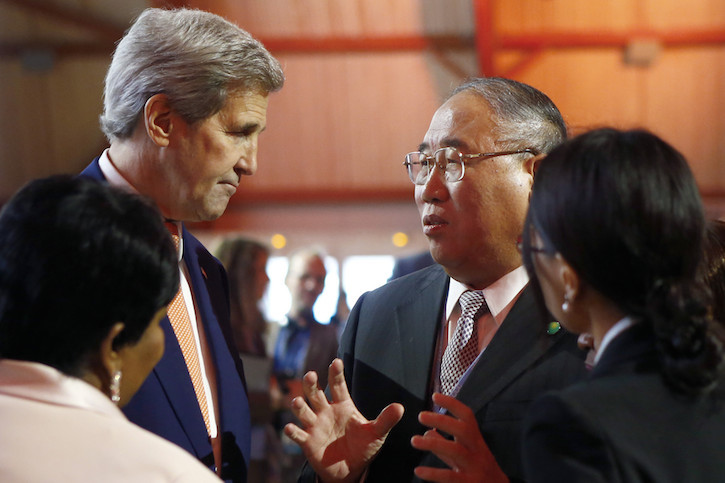 U.S. Secretary of State John F. Kerry, left, talks with China's special representative on climate change Xie Zhenhua prior to the opening of the COP21 conference in Le Bourget, France. (Francois Mori/AP)
