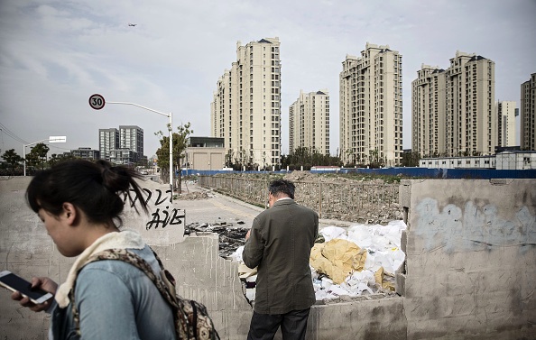 Caption: Borrowing, which has fueled many infrastructure and housing projects like this one in Shanghai, may be much higher than reported. (Qilai Shen/Bloomberg)