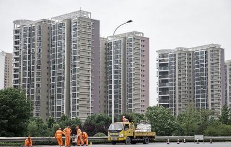 A road crew works in front of apartment buildings in Jining, China. (Qilai Shen/Bloomberg)