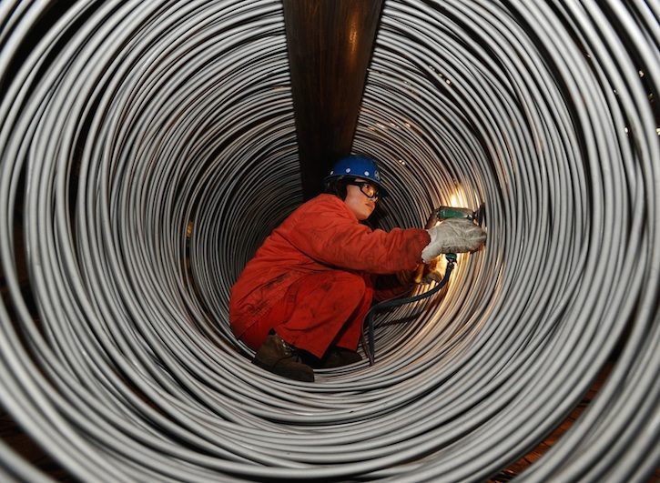 An employee works at a factory of Dongbei Special Steel Group, in Dalian, Liaoning province. The firm is at the center of a struggle between its state-owned lender and the provincial government. (Liu Debin/China Daily)